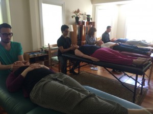 A group of people sitting on top of beds.